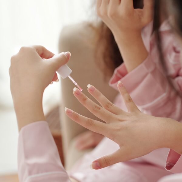 woman-applying-transparent-base-coat-on-her-nails.jpg
